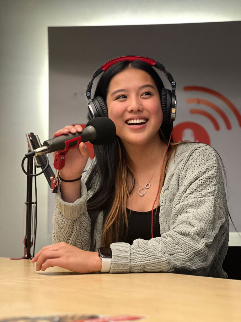 lady doing a podcast in the nam podcast studio